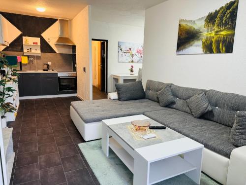 a living room with a couch and a table at Ferienwohnung Heringen in Heringen