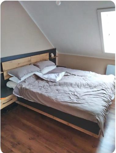 a bed with white sheets and pillows in a bedroom at Ferienhäuschen in Hildfeld in Winterberg