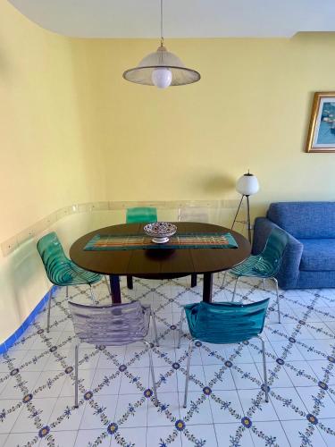 a living room with a table and a blue couch at CapoTen in Sorrento