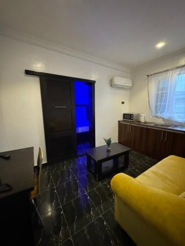 a living room with a couch and a table at Posh Hotel and Suites Ikeja in Ikeja