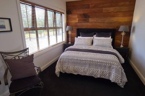 a bedroom with a large bed and a window at Apartment 4 - Haddin Court - Chic NY Loft Style in Blenheim
