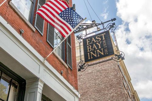 a sign for an east bay inn with an american flag at East Bay Inn, Historic Inns of Savannah Collection in Savannah