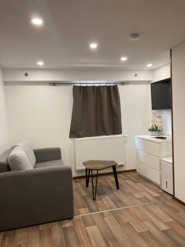 a living room with a couch and a table at Ferienwohnung Funke F4 für Monteure in Apolda