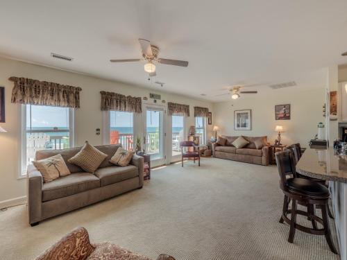 a living room with a couch and a table at Perse-vear-ance in Topsail Beach