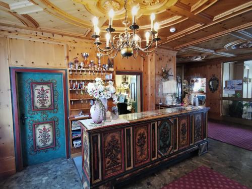 a room with a counter with a vase of flowers on it at Hotel la Plaza in Corvara in Badia
