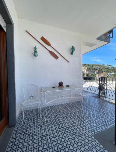 a white table and two chairs on a balcony at CapoTen in Sorrento