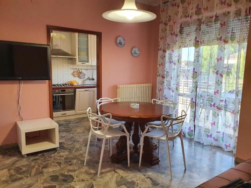 a dining room with a wooden table and chairs at Casa Vacanze Gabry in Porto San Giorgio