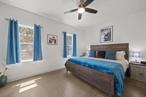 a bedroom with a bed and a ceiling fan at Terracotta Bliss Wimberley Retreat For 28 Guests in Wimberley