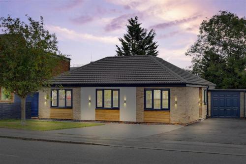 a small house on the side of a street at Brand New 4 Bed Deluxe Modern Villa - Sleeps 9 - Private Parking & Garden in Nottingham