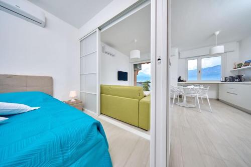 a bedroom with a bed and a yellow couch at Benaco Hause 3 in Brenzone sul Garda