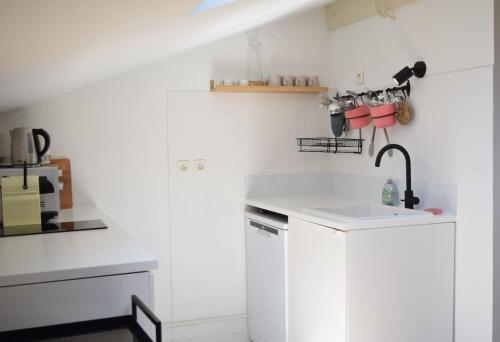 a kitchen with white cabinets and a sink at Nid de Line - Hostal Naou - Wifi-Netflix in Soorts-Hossegor