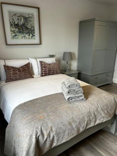 a bedroom with a bed with towels on it at Kells Ocean View Luxury Retreat in Kilkeehagh