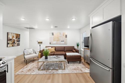 a living room with a couch and a refrigerator at The King's Retreat II in Houston