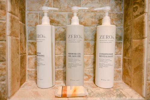 a group of three shampoo bottles on a bathroom counter at Spoonbills Sanctuary Coastal Chic 1BR Retreat 329 in South Padre Island