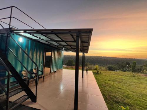 a glass house with a view of a field at Container Home Py in Puerto Presidente Franco
