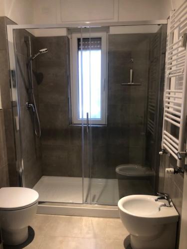 a bathroom with a shower and a toilet and a sink at Alfredo Luxury house in Rome