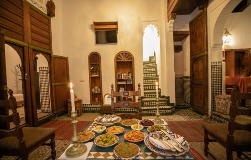 a table with many plates of food on it at Dar Authentic Fes - familly hosting in Fès