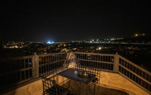 a view of a city at night from a balcony at Dar Authentic Fes - familly hosting in Fès