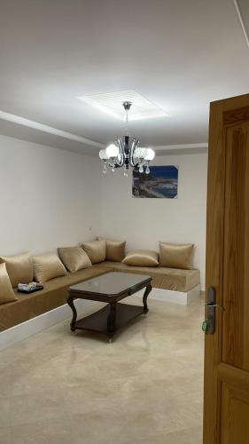 a living room with a couch and a table at Tanger Relax Appartement in Tangier