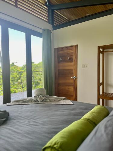 a bedroom with a large bed with a large window at Southern Drake Lodge in Drake