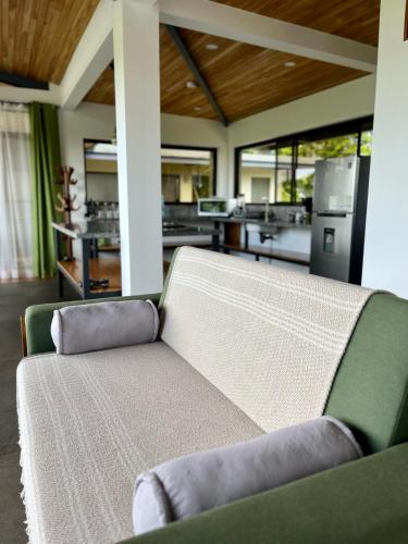 a couch in a living room with a kitchen at Southern Drake Lodge in Drake