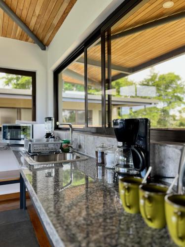 a kitchen with a counter with yellow chairs at Southern Drake Lodge in Drake