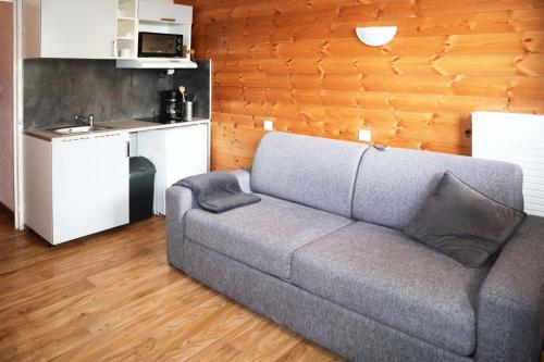 un salon avec un canapé et une cuisine dans l'établissement Residence Le 1650 - Studio pour 2 personnes cœur de station des Orres 1650 MAE-5941, aux Orres