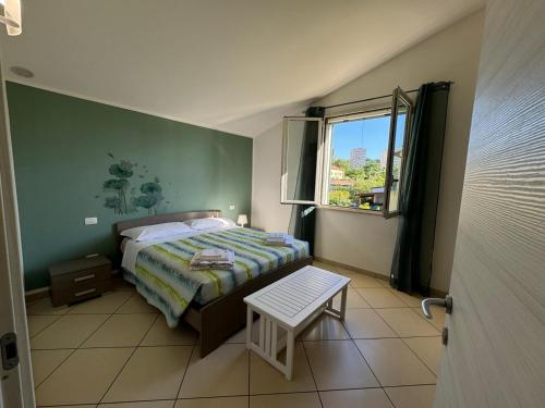 a small bedroom with a bed and a window at La casa di Glenda ospedale in Terni