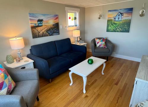 a living room with a couch and a table at Stockley's Saltbox in Twillingate