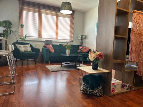 a living room with a couch and a table at Cozy Apartment with nice balcony seating, 9th floor, parking in Bratislava