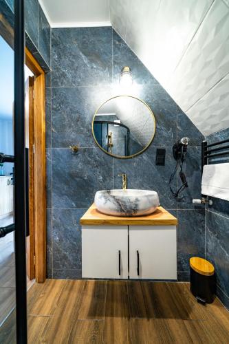 a bathroom with a sink and a mirror at Bukowiańsko Nutka in Bukowina Tatrzańska