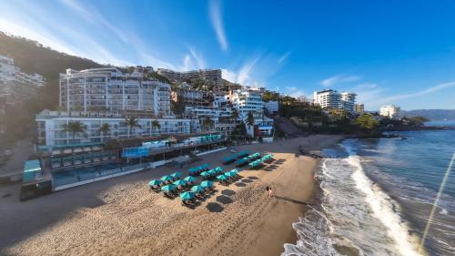 an aerial view of a beach with chairs and umbrellas at Almar LGBT Luxury Resort in Puerto Vallarta