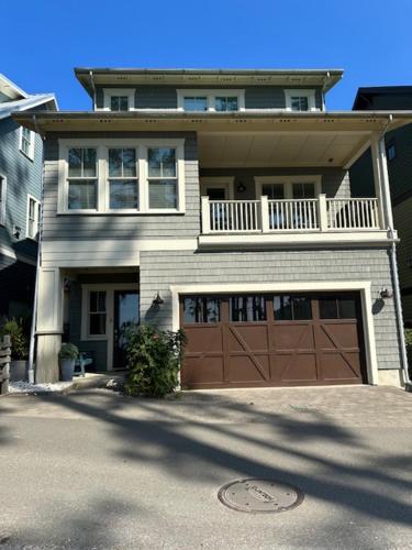 a house with a brown garage door at Into the Mystic by Seabrook Hospitality in Pacific Beach