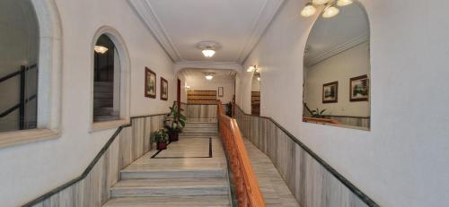 a hallway with a staircase in a building at Nacimar in O Grove