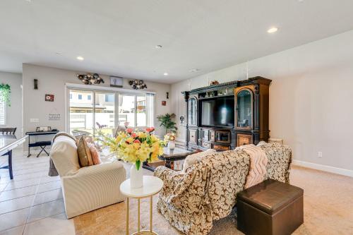a living room with a couch and a table at Beautiful Bakersfield Home about 8 Mi to Downtown! in Bakersfield