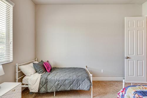 a bedroom with a bed with a pink bag on it at Beautiful Bakersfield Home about 8 Mi to Downtown! in Bakersfield