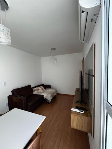 a living room with a couch and a table at Ape 307 - João Pessoa Paraíba in João Pessoa
