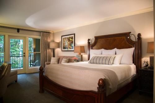 a bedroom with a large bed and a balcony at The Lodge at Woodloch in Hawley
