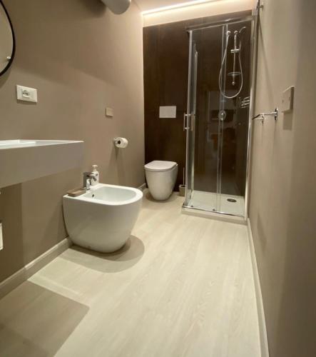 a bathroom with a shower and a sink and a toilet at Narciso boutique apartment in Acireale