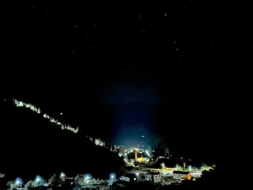a view of a city at night at ლენტეხის მთის სასტუმრო - Lentekhi Mountain Inn in Lentekhi
