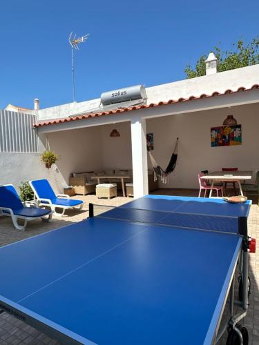 a blue ping pong table on a patio at Pirata Milfontes Guest House in Vila Nova de Milfontes