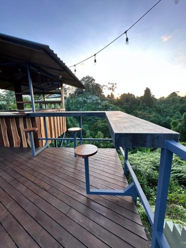 a picnic table and stool on a wooden deck at Southern Drake Lodge in Drake