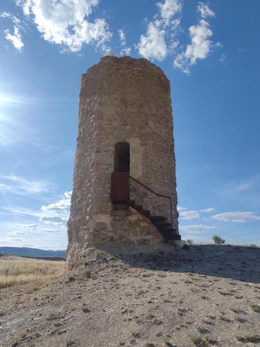 an old stone tower in the middle of a field at VUT Marcial in Calatayud