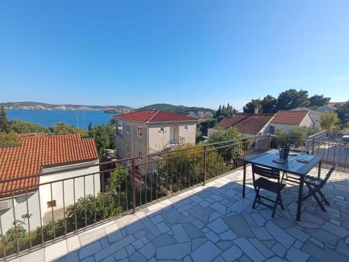 a balcony with a table and a view of the water at Apartment Koko in Rogoznica