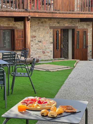 a table with a tray of food on it at Hotel Cal Rei de Talló in Bellver de Cerdanya 