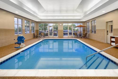 a large pool with blue water in a hotel room at Holiday Inn Express & Suites Colorado Springs-Airport by IHG in Colorado Springs