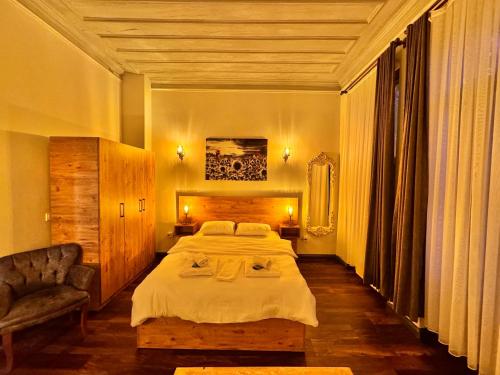 una camera con un grande letto e una sedia di Otel Kadıköy a Istanbul