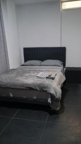 a bed with a blanket on it in a room at Residencial Salamanca in Lima