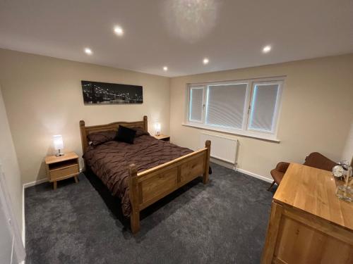a bedroom with a large bed and two night stands at Wilford Charm Spacious 3BR Retreat in Nottingham in Nottingham