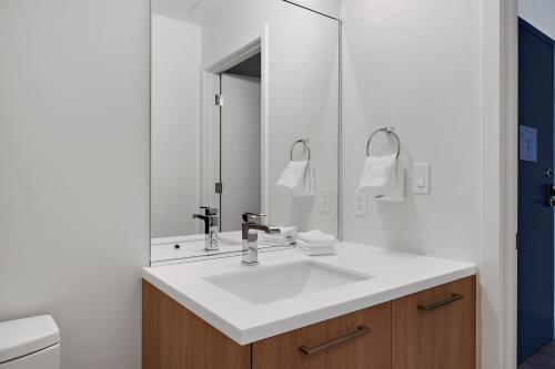 a bathroom with a sink and a mirror at Modern Lifestyle Loft with View - Zuni Lofts in Denver
